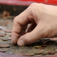 A hand holding coins
